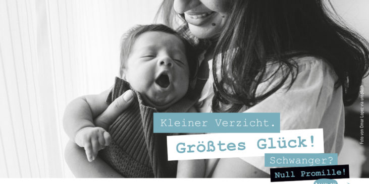 Ein neugeborenes Baby im Arm seiner lachenden, glücklichen Mutter